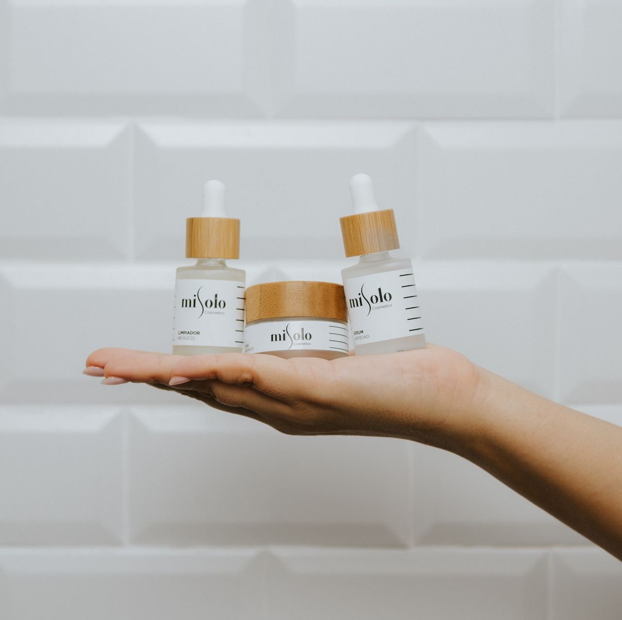 Mastering the First Impression: Your intriguing post title goes here Three luxury skincare products showcased on an open hand against a minimalist background.