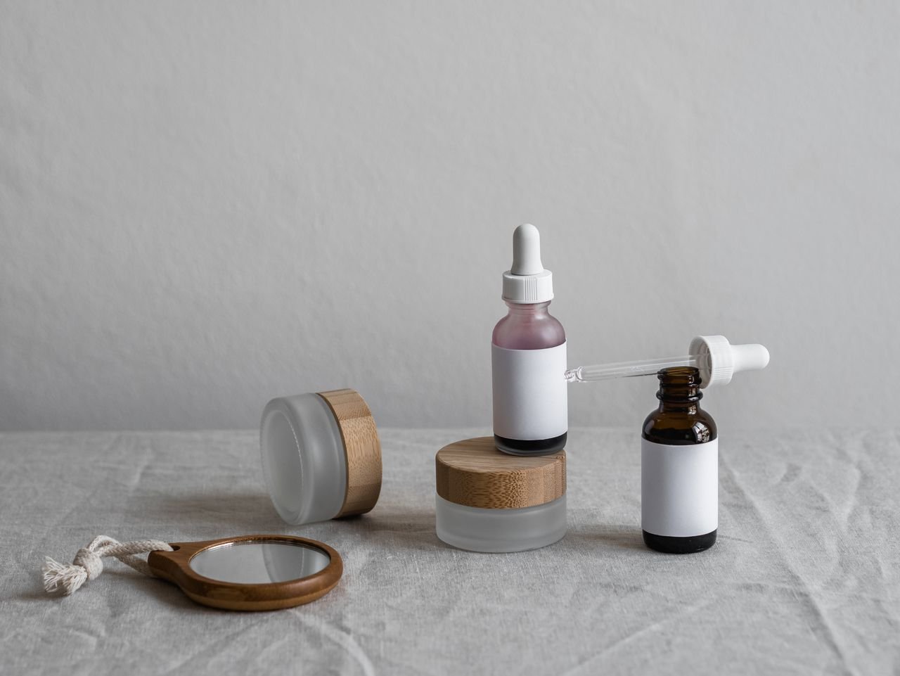 product-04 Elegant display of skincare bottles with droppers on a neutral backdrop, perfect for beauty brands.